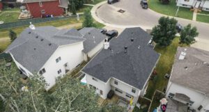 Aerial view of suburban neighborhood with houses and backyards.